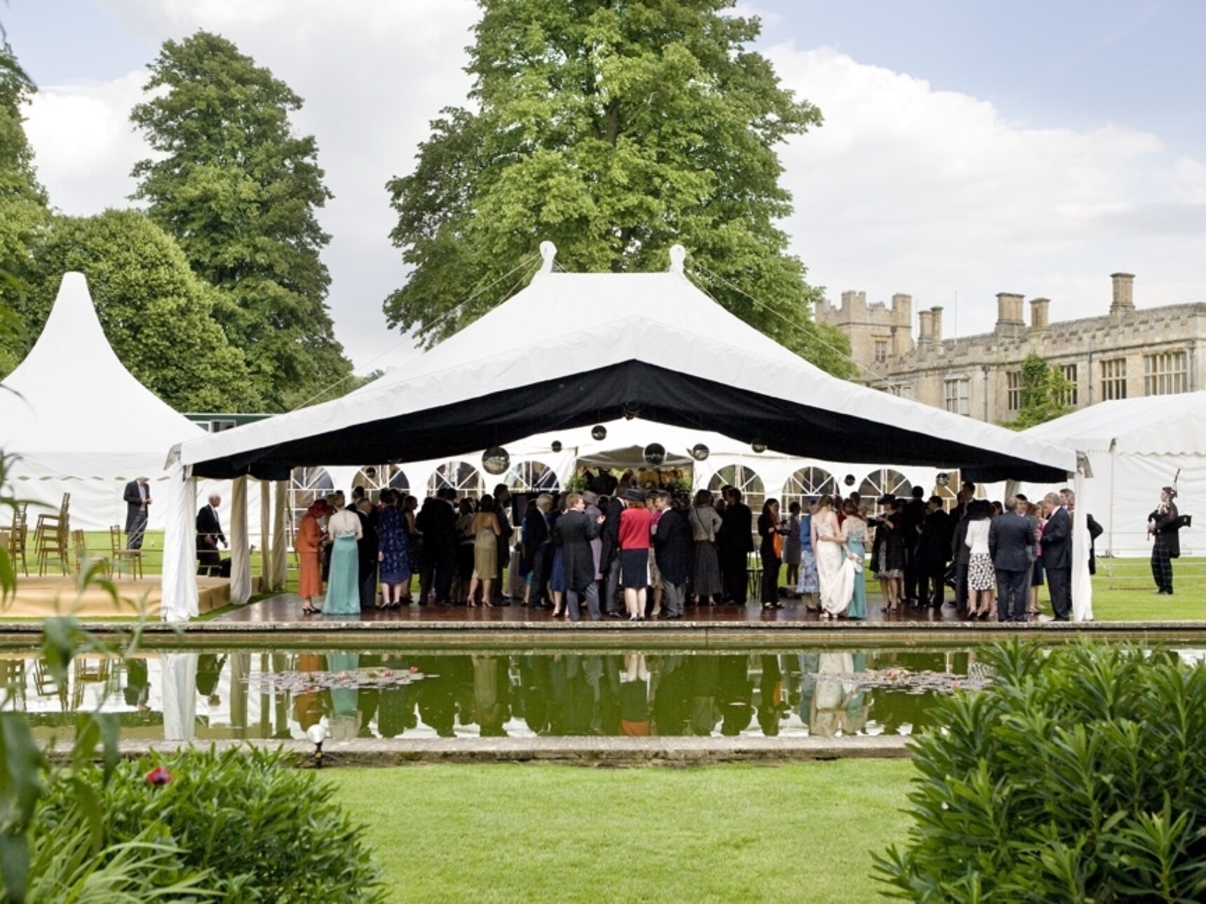 North Lawn wedding party in front of the Tithe Barn and pond